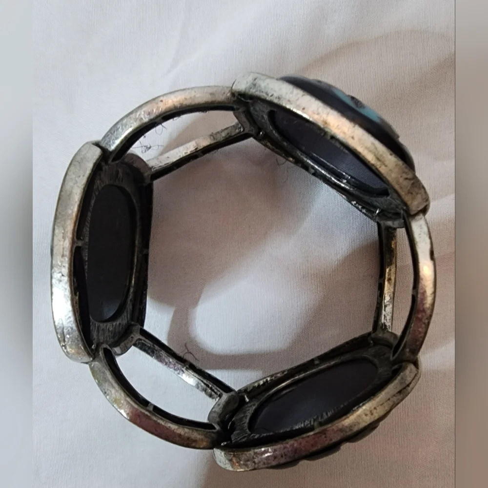Cuff bracelet with a large, square, blue and black stone set in a Silver Tone